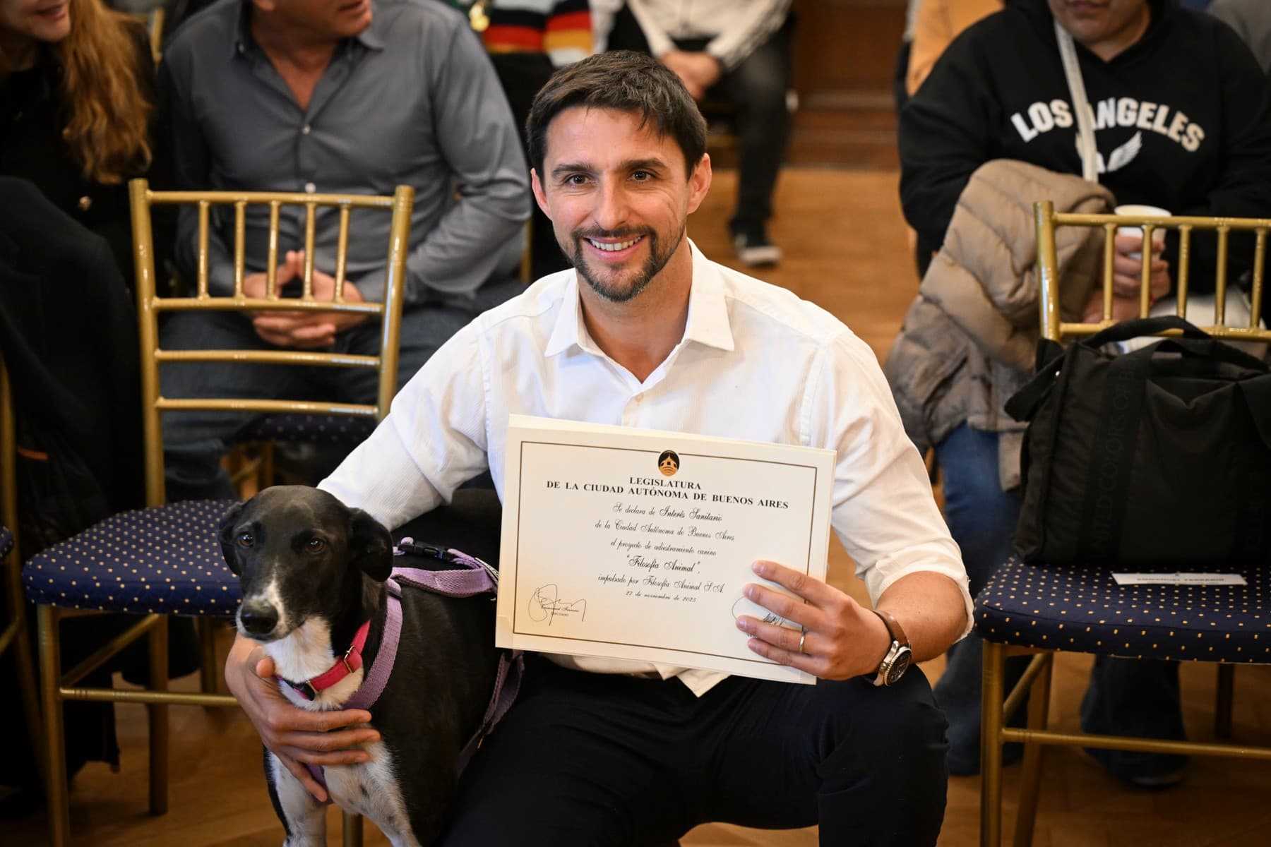 Juan Manuel Liquindoli con su perro y el diploma de la Legislatura de la Ciudad Autónoma de Buenos Aires